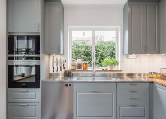 Denco31 Luxury Light Grey Shaker Kitchen Cabinets | Brass Hardware & Stainless Steel Countertops